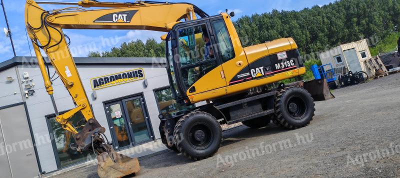 Rotační rýpadlo Caterpillar M313C s gumovými koly