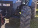 TM 155 New Holland with cultivator wheel set for sale