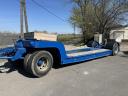 Heavy machinery trailer with low bed, red plates