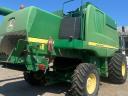 John Deere W650 combine harvester with grain table, with transport wagon