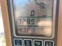 John Deere W650 combine harvester with grain table, with transport wagon